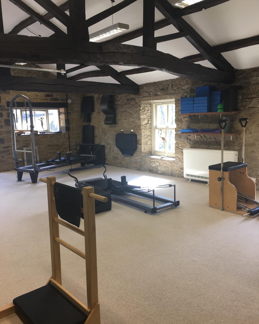 We often get asked if we do reformer classes.
Yes we have two reformers, but no we don’t run reformer classes exclusively.
As a Comprehensive Pilates Instructor, I teach the entire Pilates system - not just reformer classes - because Joseph Pilates designed his method as an interconnected, full-body approach using a variety of apparatus, each serving a unique purpose within the system.
The full Pilates system includes the Reformer, Cadillac, Wunda Chair, Ladder Barrel, Spine Corrector, Mat, and several smaller pieces of equipment. Each apparatus is designed to complement the others, helping the body find balance, strength, and control through a progressive and intelligently structured method. By working with the full range of equipment, I can tailor sessions precisely to each individual’s needs - whether that means supporting, challenging, or refining their movement in a way that a one-size-fits-all reformer class simply cannot.
While reformer classes can offer a great workout, they tend to be more generalised. Everyone in the room performs the same sequences, often at a similar pace, using the same springs and setup. The focus is typically on fitness rather than the therapeutic and corrective power of Pilates as a complete system.
In contrast, teaching the full system allows for a far more holistic and personalised experience. I can choose the right apparatus for each client’s body and goals on any given day - using the Cadillac to build stability, the Chair to develop power and balance, or the Barrels to restore alignment and flexibility. This way, the work meets the body where it is, rather than forcing the body to fit the work.
Ultimately, teaching the full Pilates system honours the original intention of Joseph Pilates - a complete method of movement that integrates mind, body, and spirit, and restores natural strength and vitality through precision and progression. It’s not just a class - it’s a whole-body education in movement.