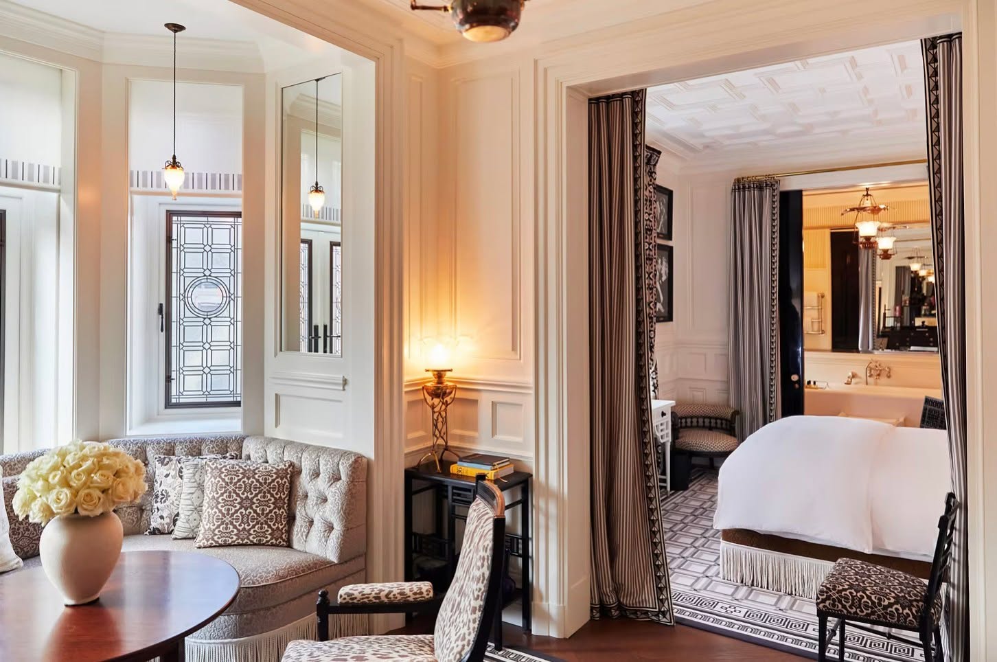 Tucked into the heart of Chelsea, just off Chelsea's Sloane Square, …At Sloane is the vision of Jean-Louis Costes, marrying understated British elegance with unmistakable Parisian attitude. It's a hotel built for candlelit dinners, late-night cocktails, and lingering intimate moments.
The Suite Sloane captures that mood best. At 46 square meters, the suite is designed by François-Joseph Graf, with bay windows overlooking Sloane Square and the residential street below. A living room, separated from the bedroom by patterned curtains, holds a banquette and table for quiet mornings or an evening drink before heading out. The bedroom itself centers on a king-size bed, with a walk-in wardrobe and a spacious bathroom featuring a freestanding bath tub, walk-in shower, and twin sinks. Costes bath products and a curated selection of books and artwork, unique to each suite, round out the details. It's a suite designed less for sightseeing between stops and more for lingering, exactly the kind of space that turns a London stay into a romantic escape. Contact the Dominique Debay Collection for preferred partner amenities and details: info@dominiquedebay.com | 1-212-752-1416 | WhatsApp 1-917-940-2407 #dominiquedebaycollection #lifeatsloane #RomanticEscape #AtSloane #ChelseaLondon #LuxuryTravel
