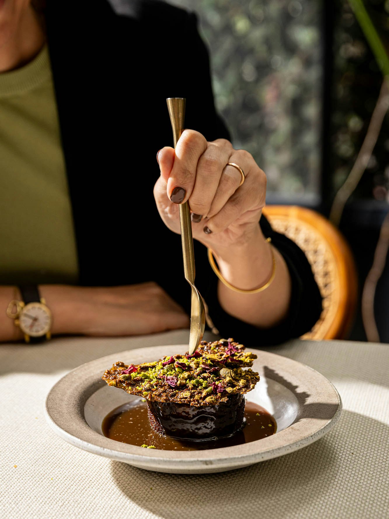 Our decadent sticky date pudding crowned with molasses, rose petals, and pistachios - finished with a luscious salted tahini custard. 😍