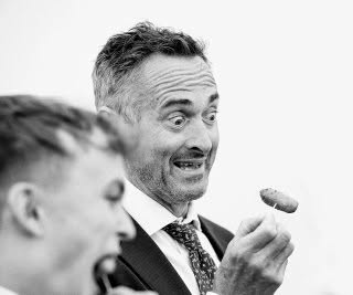 Scary sausage on a stick at Tom and Yuri"s Norfolk wedding. #weddingphotographeruk #weddings #fearlessphotographerscom #gettingmarried #documentaryweddingphotography #norfolkwedding ##norfolkweddingphotographer #candidphotography #reportageweddingphotography #bridebook #theknot #madewithmastin #bestweddingphotographers