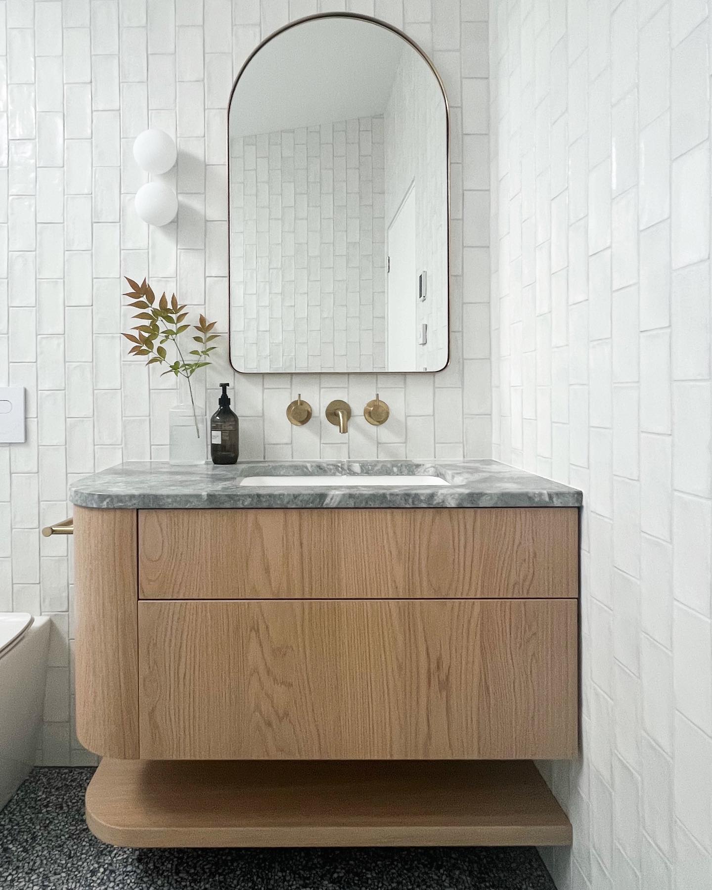 Finally got back to visit this bathroom in Central Otago completed early this year. I love the large skylight, it throws light over the spacious twin shower + you get to 🚿 with a view 🌲 ⛅️ Bonus.
Simple texture on the walls with vertically laid subway tiles that have a beautiful wavy finish & paired with some statement terrazzo.
Brushed brass tapware throughout, oak for some warmth & a few curves to soften. 💛#ttdproject
Build by @gunsblazingconstruction