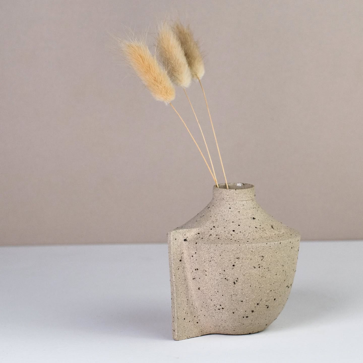 A one-of-a-kind little bud vase. No two are ever the same. Each vase begins with the same weight of clay, but is shaped individually by hand on the wheel, giving every piece its own unique form and character. In a world of mass production, there’s something special about holding and displaying an item that is truly unique.
This vase is available on my website along with its friends.