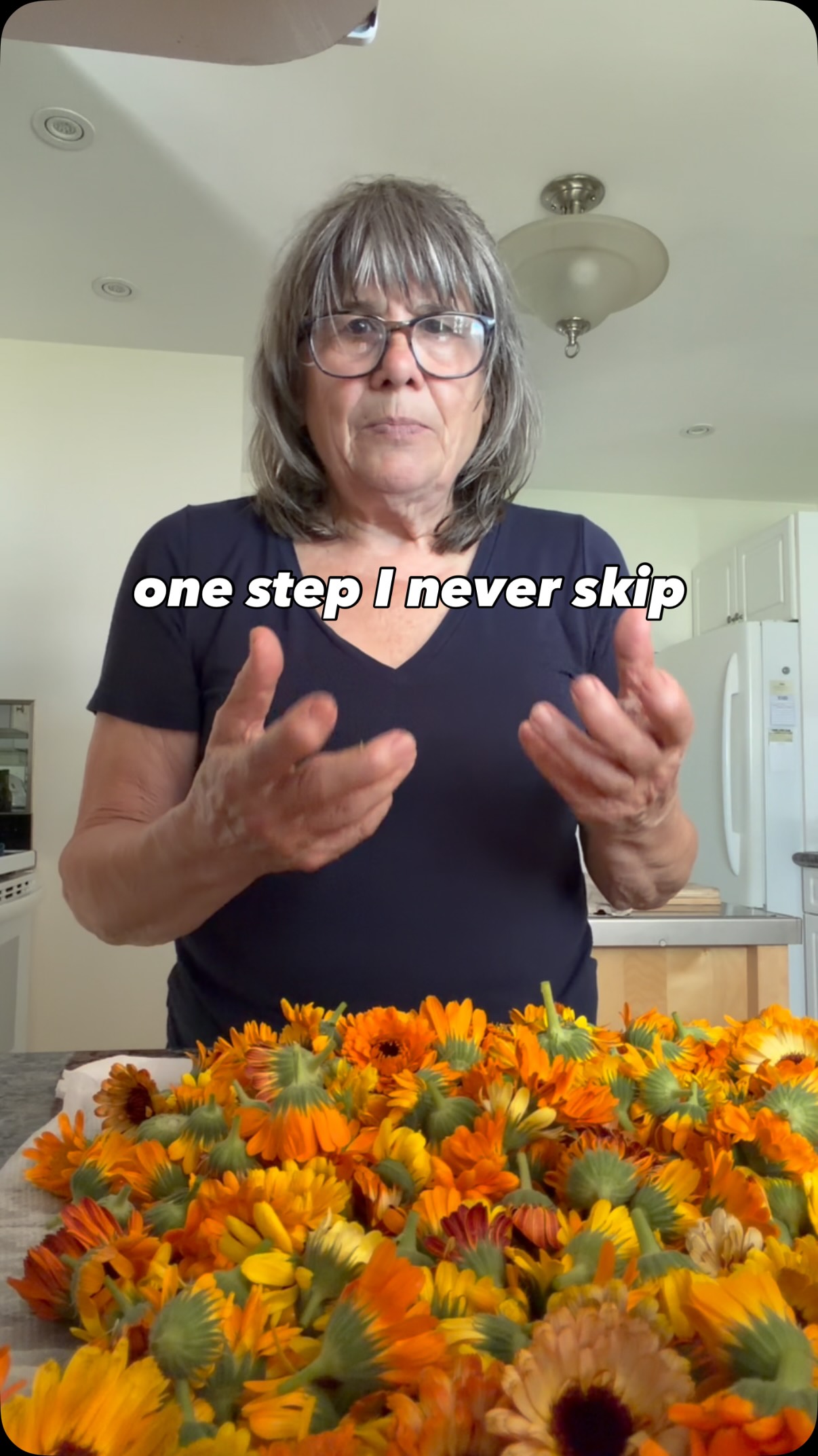 One step I never skip is washing my calendula before drying it.
I know not everyone does, and there are good reasons for that—it can add a little extra drying time.
For me, it’s worth it.
My flowers grow outside, and I’d rather take a few extra minutes to rinse away dust, pollen, and any little hitchhikers before they become part of the oils I infuse for my skincare.
After washing, they dry on paper towels first, then go into the dehydrator until they’re completely crisp. Only then are they ready to be stored until it’s time to infuse them.
It’s a slower process, but it’s the one that feels right to me.
Do you wash the herbs or flowers you dry, or do you leave them as they are?